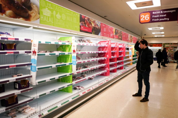 A man stands next to shelves empty of fresh meat in a supermarket, as the number of worldwide coronavirus cases continues to grow,  in London, Britain, March 15, 2020. REUTERS/Henry Nicholls