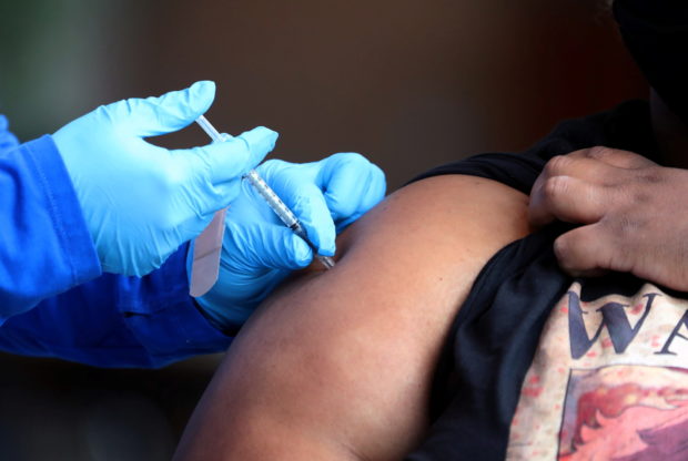 A student receives a dose of a coronavirus disease (COVID-19) vaccine on the campus of the University of Memphis in Memphis, Tennessee, U.S., July 22, 2021. 