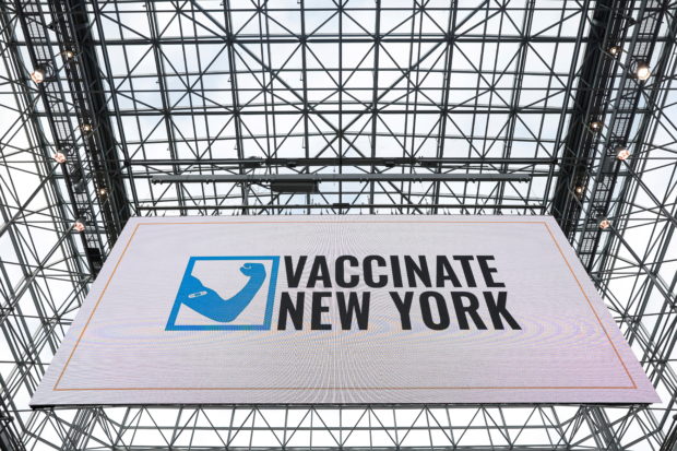 Sign reading "Vaccinate New York" is seen at the New York State coronavirus disease (COVID-19) vaccination site at the Jacob K. Javits Convention Center, in New York City, U.S., January 13, 2021