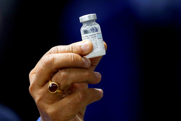 Indian Health Minister Harsh Vardhan holds a dose of Bharat Biotech's COVID-19 vaccine called COVAXIN, during a vaccination campaign at All India Institute of Medical Sciences (AIIMS) hospital in New Delhi, India, January 16, 2021