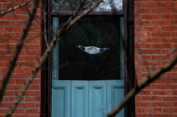 A protective mask is seen on a window during the outbreak of the coronavirus disease (COVID-19) in the Brooklyn borough of New York City, U.S., April 26, 2020. 