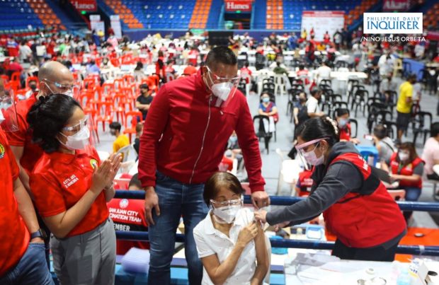 San Juan City residents get inoculated with a single dose of Johnson & Johnson's at the FilOil Flying V Center