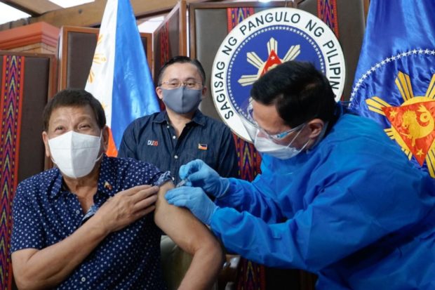 President Rodrigo Duterte receives his second dose of the Sinopharm COVID-19 vaccine administered by Health Secretary Francisco Duque III. Courtesy Senator Bong Go.