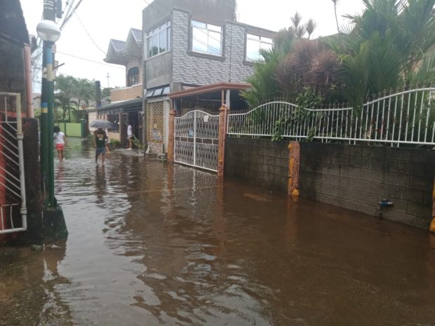 This street at Barangay Maysantol in Bulakan town remains flooded due to incessant rain and high tide