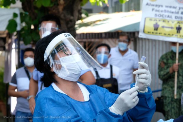 A health worker in Ilocos Norte prepares to administer a vaccine against COVID-19