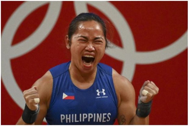 Philippines’ Hidilyn Diaz reacts after placing first in the women’s 55kg weightlifting competition during the Tokyo 2020 Olympic Games at the Tokyo International Forum in Tokyo on July 26, 2021.