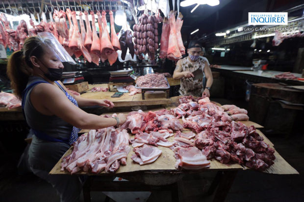 Meat vendors at Commonwealth Market. STORY: Local pork supply slightly down