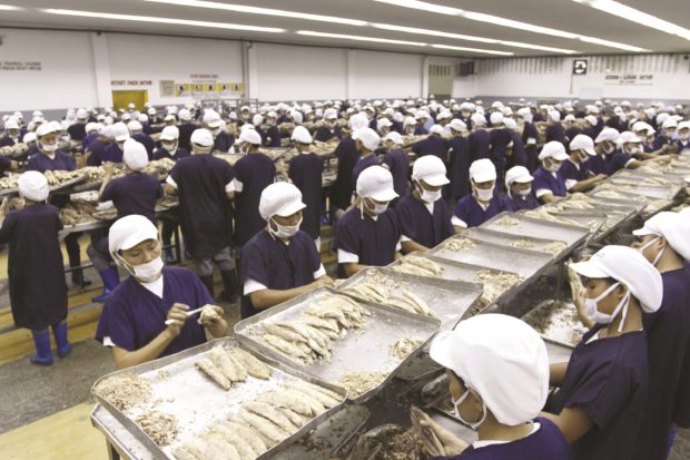 Workers in a tuna processing plant. STORY: Groups urge gov't to uphold international labor standards