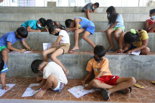 FILE Children from Agoncillo town in Batangas who were displaced by the eruption of Taal Volcano were busy coloring COVID-19 flyers provided by social workers. Minors aged 12 to 17 may soon be inoculated against COVID-19. — NIÑO JESUS ORBETA