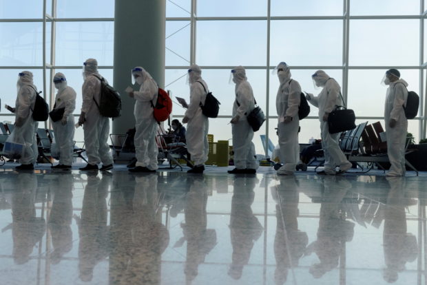 china coronavirus people wearing PPE airport