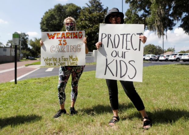 Supporters of wearing masks in schools protest before the special called school board workshop at the Pinellas County Schools Administration Building in Largo, Florida, U.S., August 9, 2021. REUTERS/Octavio Jones/File Photo