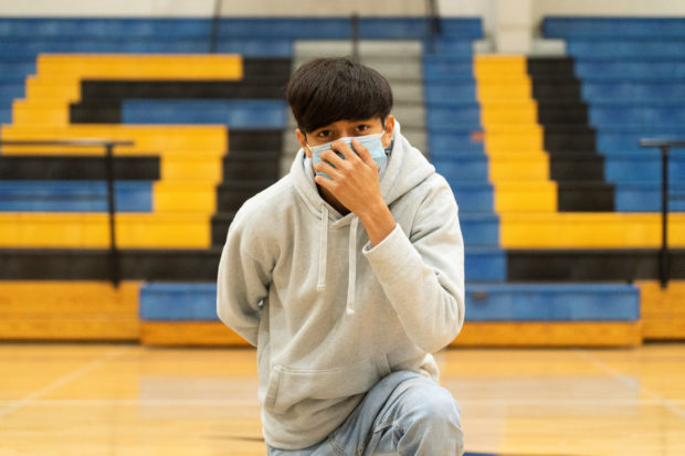 A sophomore student at Louise High School Antonio Martinez, 15, also a cross country runner, wears a mask as he poses, during the coronavirus disease (COVID-19) pandemic in Louise, Texas, U.S., 