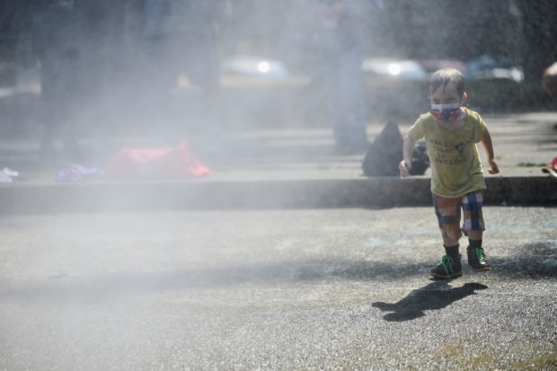 A child cools off at a misting station in Lents Park as a heat wave continues in Portland, Oregon, U.S., August 12, 2021. 