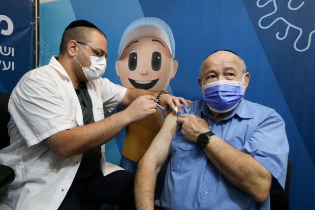 A man receives his third dose of the coronavirus disease (COVID-19) vaccine at a Clalit healthcare maintenance organisation in Jerusalem
