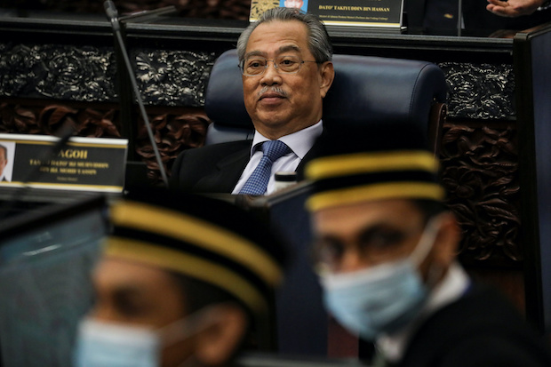 Malaysia's Prime Minister Muhyiddin Yassin reacts during a session of the lower house of parliament, in Kuala Lumpur