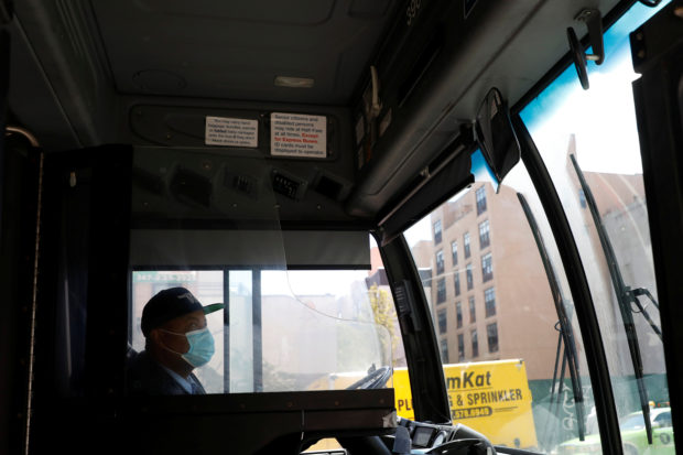 A bus driver wears a face mask during the outbreak of the coronavirus disease (COVID-19) in the Manhattan borough of New York City, U.S., May 9, 2020. REUTERS/Andrew Kelly
