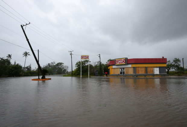 A road next to a convenience store is flooded after Hurricane Grace slammed into the coast with torrential rains, in Costa Esmeralda, near Tecolutla, Mexico August 21, 2021. 
