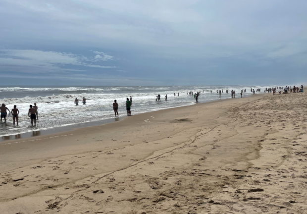 Residents and holiday makers in the Hamptons make the most of the calm before the storm at Atlantic Avenue beach ahead of Hurricane Henri's landfall, Long Island, New York, U.S.