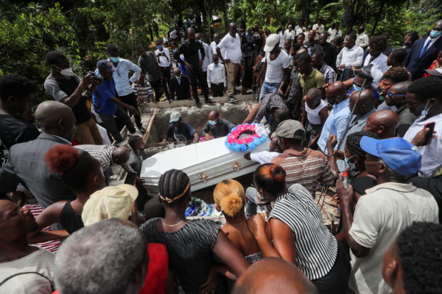 People take part in a funeral after the earthquake that took place on August 14th, in Marceline near Les Cayes, Haiti August 21, 2021. REUTERS/Henry Romero