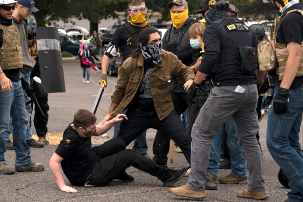 Members of the Proud Boys clash with counter-protesters