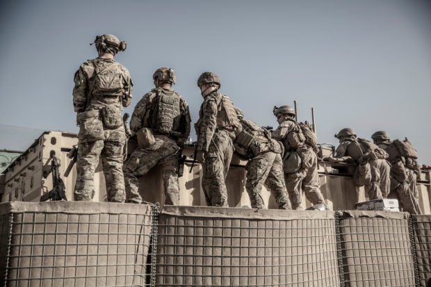 U.S. service members assist with security at an Evacuation Control Check Point (ECC) during an evacuation at Hamid Karzai International Airport, Kabul, Afghanistan, August 26, 2021. Picture taken August 26, 2021. U.S. Marine Corps/Staff Sgt. Victor Mancilla/Handout via REUTERS. 