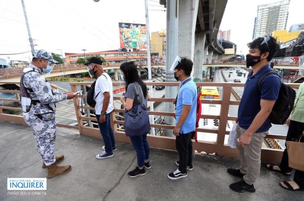 Passengers riding the Edsa Carousel bus form a long line at the Roosevelt Station in Quezon City, as members of the Inter-Agency Council for Traffic asks them for APOR documents