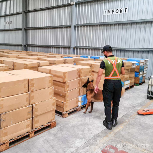 Bureau of Customs (BOC) agents inspect the alleged fake cigarettes shipments at Subic Bay Freeport