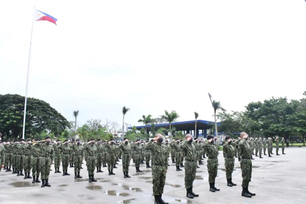 Rookie policemen execute the hand salute during their formation at Camp Julian Olivas in the City of San Fernando, Pampanga province