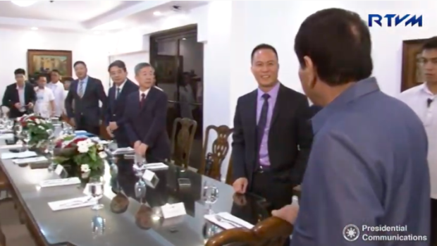 Former presidential adviser on economic affairs Michael Yang with President Duterte during a meeting with officials of Pharmally Pharmaceuticals in Davao City. Image from the March 18, 2017 video of RTVM Malacañang 