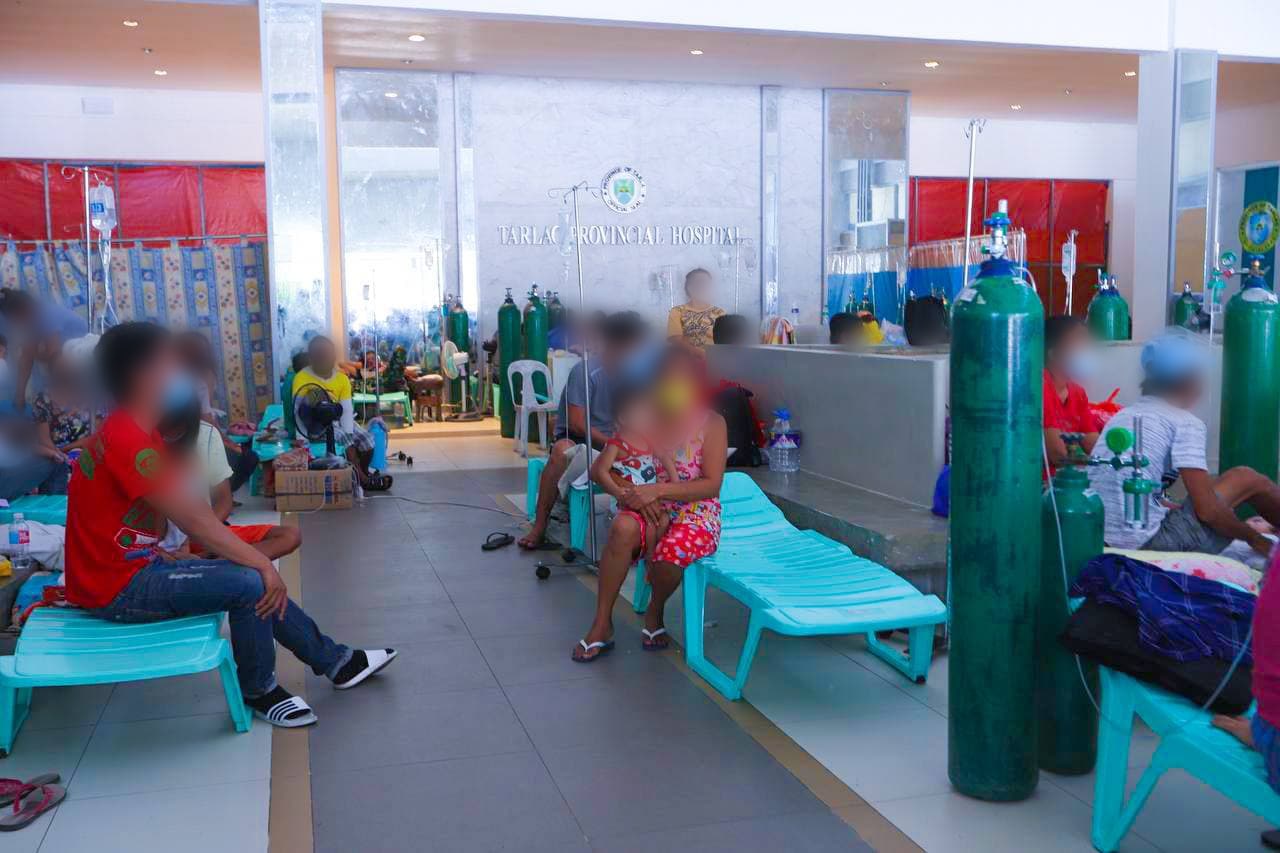Patients wait at the triage or screening area of the Tarlac Provincial Hospital to undergo testing for COVID-19 before getting admitted for treatment