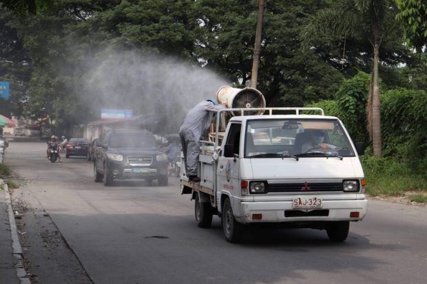 A government truck disinfects the roads in Angeles City