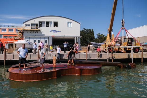 A boat in the shape of a giant violin, built as an homage to people who have died from COVID-19, had a test voyage in Venice on Friday as a cellist played on the deck.