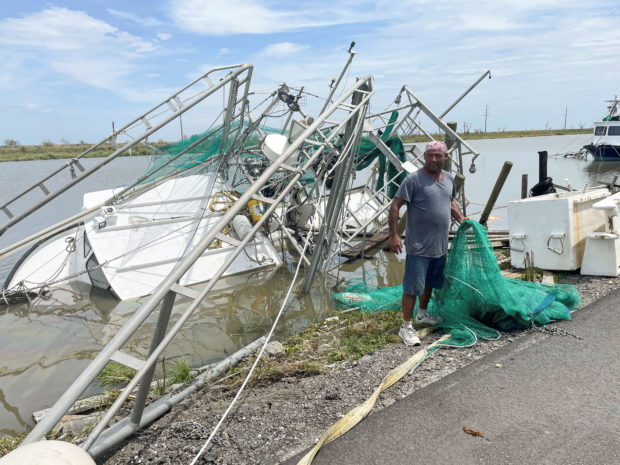 Shrimpers survey the damage to homes and shrimp boats after Hurricane Ida  made landfall in Golden Meadow, Louisiana, U.S., August 31, 2021. 