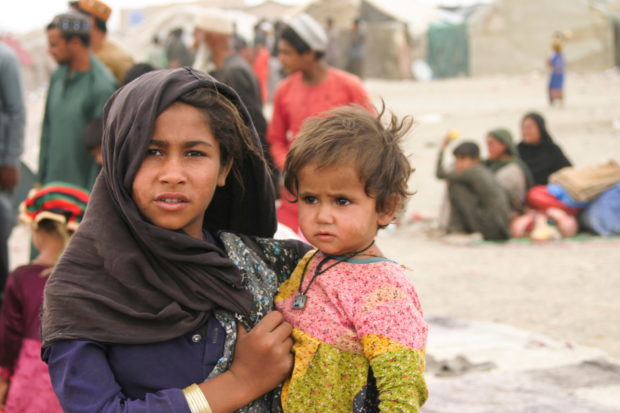 FILE PHOTO: Siblings who arrived from Afghanistan with their families are seen at their makeshift tents as they take refuge near a railway station in Chaman