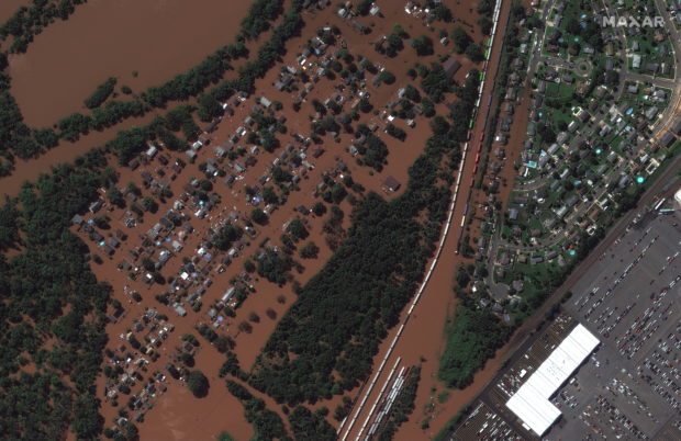 A satellite image shows a rail yard and homes along Huff Avenue submerged in floodwater after torrential rains swept through Manville, New Jersey, U.S., following the passing of Hurricane Ida, September 2, 2021. Satellite image copyright 2021 Maxar Technologies/Handout via REUTERS