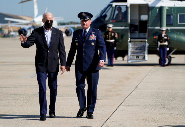 U.S. President Joe Biden walks on the tarmac with Col. Matthew E. Jones, Commander of the 89th Airlift Wing, before departing to visit New York and New Jersey to tour the hurricane-affected areas, from Joint Base Andrews, Maryland, U.S. September 7, 2021. REUTERS/Elizabeth Frantz