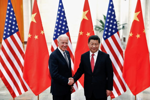  Chinese President Xi Jinping shakes hands with U.S. Vice President Joe Biden (L) inside the Great Hall of the People in Beijing December 4, 2013. REUTERS/Lintao Zhang/Pool//File Photo