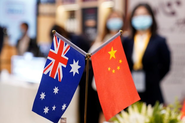 FILE PHOTO: Australian and Chinese flags are seen at the third China International Import Expo (CIIE) in Shanghai, China November 6, 2020. REUTERS/Aly Song
