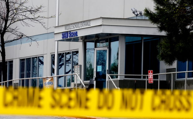 FILE PHOTO: Crime scene tape is seen outside the school following the shooting at the Science, Technology, Engineering and Math (STEM) School in Highlands Ranch
