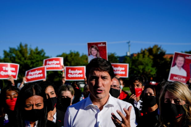 Canada's Liberal Prime Minister Justin Trudeau speaks to reporters at an election campaign stop on the last campaign day before the election, in Montreal, Quebec, Canada September 19, 2021. REUTERS/Carlos Osorio