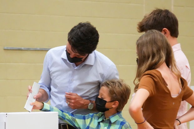 Canada's Liberal Prime Minister Justin Trudeau casts his ballot with his son Hadrien next to his daughter Ella-Grace and his son Xavier on election day, in Montreal, Quebec, Canada September 20, 2021. REUTERS/Carlos Osorio