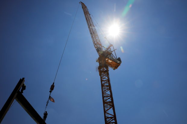 Members of the Ironworkers Local 7 union install steel beams on a high-rise building under construction during a summer heat wave in Boston, Massachusetts, U.S., June 30, 2021.   REUTERS/Brian Snyder