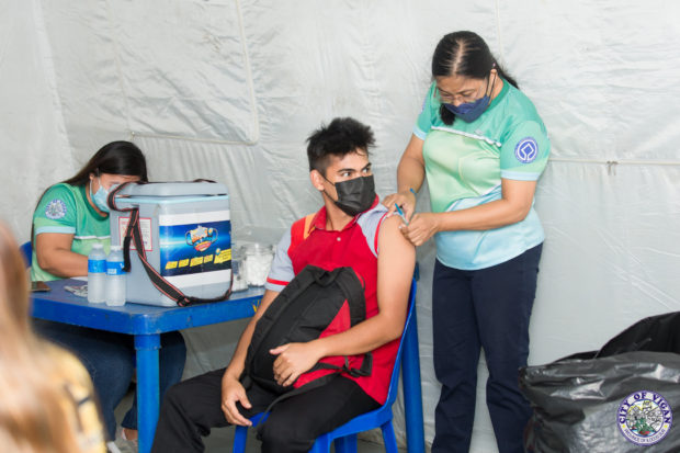 An essential worker in Ilocos Sur province receives a COVID-19 vaccine