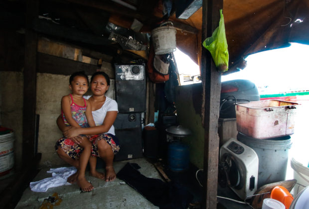 Jocel Madrano, 23, lives with her husband and four children in a shack built over Manila Bay, supported by wooden stilts. Despite their precarious living conditions, life goes on in this small community of around 100 families in Tondo, in the capital Manila