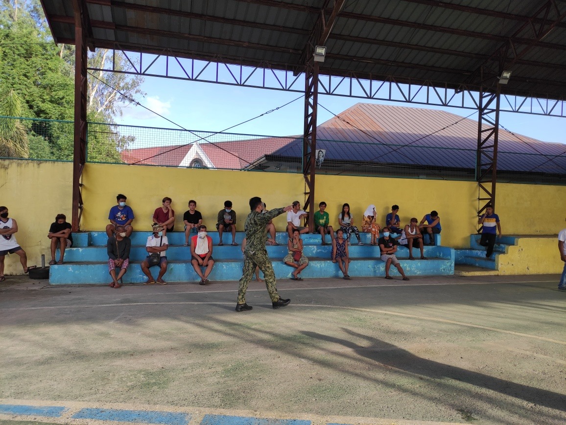 Quarantine rules violators are brought to a covered court in Mexico, Pampanga