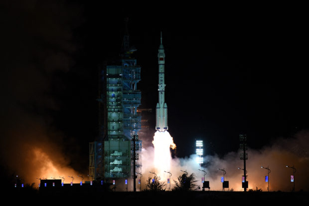 A Long March-2F carrier rocket, carrying the Shenzhou-13 spacecraft with the second crew of three astronauts to China's new space station, lifts off from the Jiuquan Satellite Launch Centre in the Gobi desert in northwest China early on October 16, 2021. - China launched a rocket carrying three astronauts to its new space station on what is set to be the country's longest crewed mission to date, state media Xinhua said, the latest landmark in Beijing's drive to become a major extraterrestrial power. (Photo by STR / AFP) 