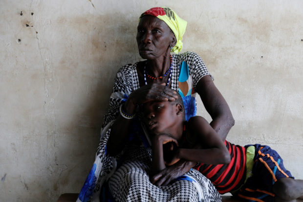 A woman comforts her son, who is suffering from malaria, as they wait for treatment at a Medecins Sans Frontieres (MSF) run clinic in the village of Likuangole, in Boma state, east South Sudan, February 1, 2017. REUTERS/Siegfried Modola SEARCH "FAMILY MODOLA" FOR THIS STORY. SEARCH "WIDER IMAGE" FOR ALL STORIES.   TPX IMAGES OF THE DAY? - RC1A51FF27E0