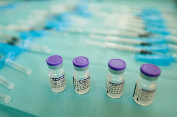 FILE PHOTO: Vials and syringes filled with the "Comirnaty" Pfizer BioNTech vaccine against the coronavirus disease (COVID-19) are seen on a table at a nursing home in Seville, Spain September 21, 2021. REUTERS/Marcelo del Pozo