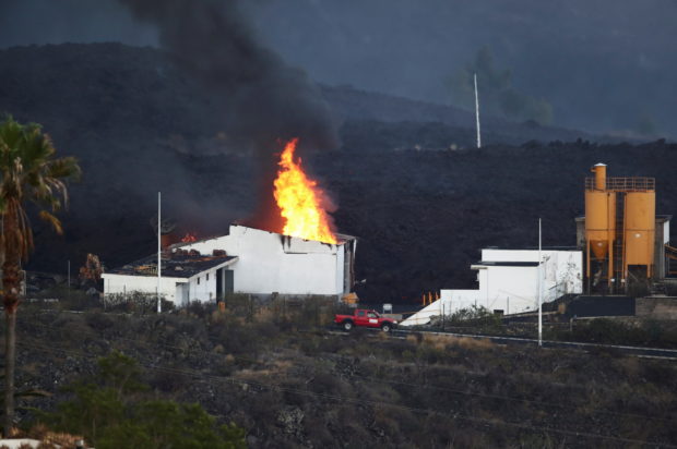 Lava from La Palma volcano burns cement plant, prompting lockdown