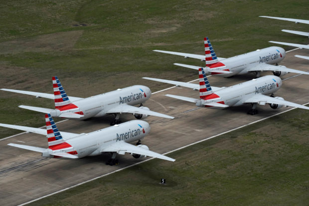 FILE PHOTO: American Airlines passenger planes crowd a runway where they are parked due to flight reductions to slow the spread of coronavirus disease (COVID-19), at Tulsa International Airport in Tulsa